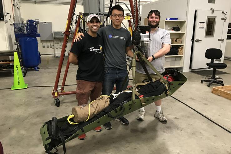 Computer science master's student Mahdi Al-Husseini, left, with the Stabilizing Aerial Loads Utility System he created with Stan