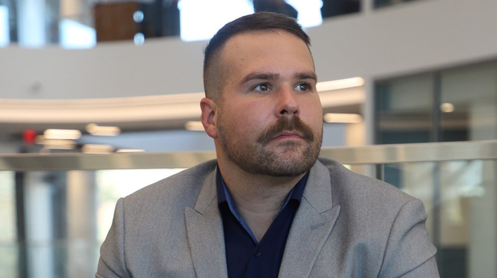 Adam-MacCallum,Jim Pope Fellow and translational research advocate in Georgia Tech’s Wallace H. Coulter Department of Biomedical Engineering, sits pensively, looking out.
