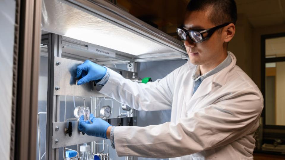 Man in a lab holding samples